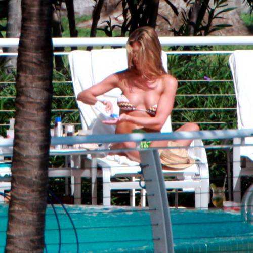 Jennifer Aniston takes time out of her busy day to sunbathe at her hotel in...
